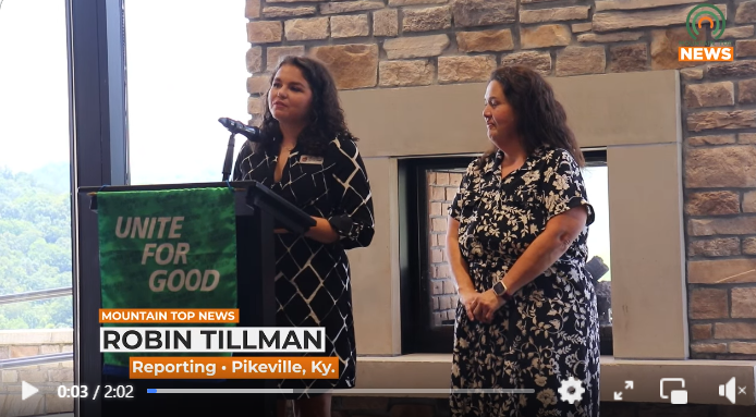 Two women stand at a podium and give a presentation