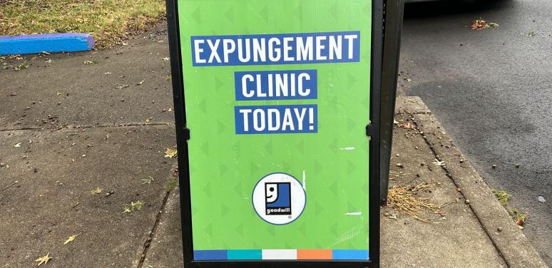 Green sign reads expungement clinic today