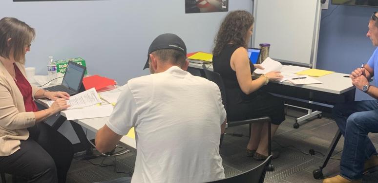 Attorneys help community members at a clinic