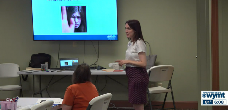 Attorney stands in front of powerpoint