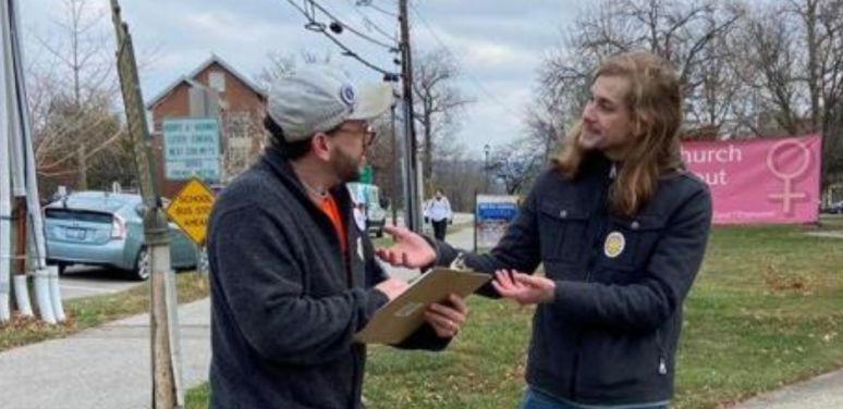 Michael Harrington speaks with Michael Harrington speaking with a fellow Madison County tenant.