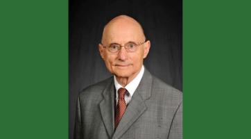 Photo of Rosenberg in a gray suit